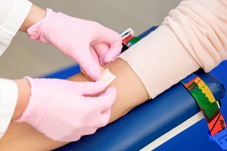 Nurse disinfecting arm skin by cotton before giving a injection vaccine in medical center.の写真素材