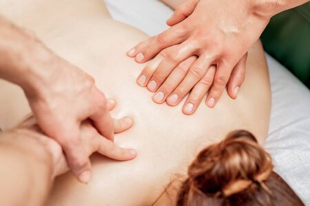 Close up of sensual thai massage in four hands by fingers in spa salon.の写真素材