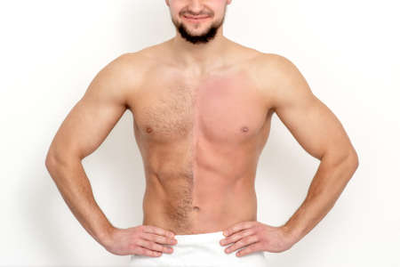 Young caucasian man with bare chested before and after waxing his hair stands on white backgroundの写真素材