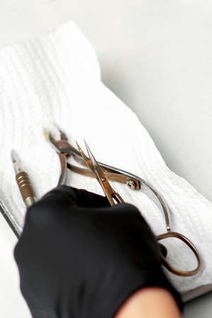 Professional manicure master prepares nail care tools on a white background with copy spaceの写真素材