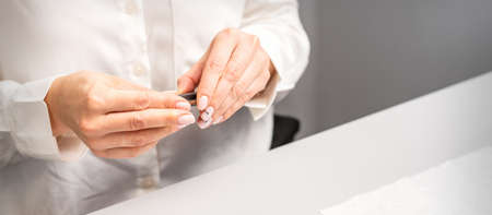 Professional manicurist preparing tools for doing clients nailsの写真素材