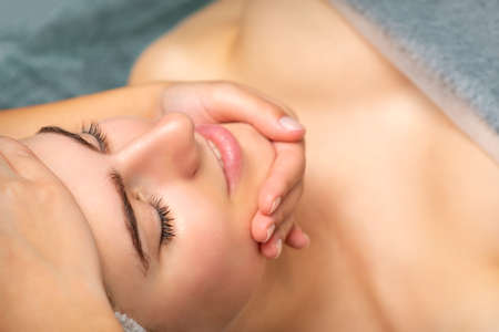 Face massage of detox therapy for the pretty female patient at spa salonの写真素材