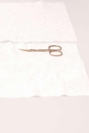 Hands of manicure master prepare nail care tools on a white tableの写真素材