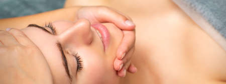 Face massage of detox therapy for the pretty female patient at spa salonの写真素材