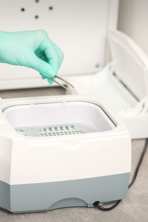 Hand disinfects tweezers with cleaning systems for medical instruments. Ultrasonic cleaner