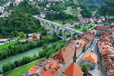 Fribourg is located on the Swiss plateau  Its old city sits on a small rocky hill above the valley  Most houses are built of the local stone in Gothic style  The town is buried in verdure の写真素材