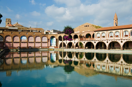 An outdoor swimming pool is situated in the ancient Spanish estate within the spa resort のeditorial素材