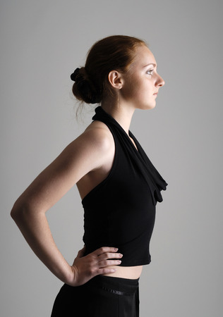 Girl with red hair arranged on back of the head in the black blouseの写真素材