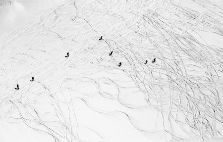 Mountain-skiers are sliding down on the snow hillの写真素材