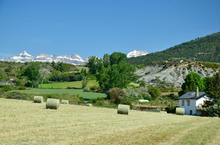 Gathered field with straw packages are photographed in the foothills of the Spanish Pyrenees のeditorial素材