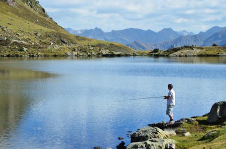 Pyrenees, France - 04 October 2014: A man no-kill fishes in the catch and release angling area on the mountain lake in the Pyrenees.のeditorial素材
