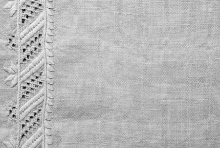 The white homespun cloth is decorated with the handmade embroidery along the left side. It is made...