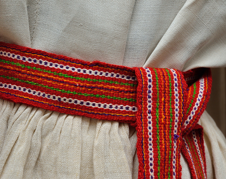 The wool woven belt is wrapped around and photographed closely. This is an important object of the Ukrainian national costume.の写真素材