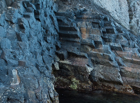 Volcanic rocky wall is photographed closely in the natural park Scandola.
