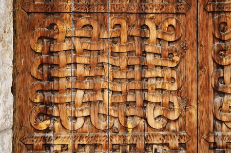 Ornamented surface of the carved wooden doorの写真素材