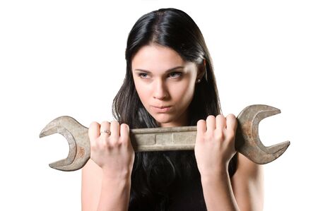 The beautiful woman in a black dress with a spanner in hands.の写真素材