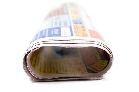 newspaper rolled up, isolated on white backgroundの写真素材