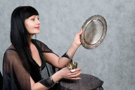 Beautiful woman of forty-five years   and silver wineglassの写真素材