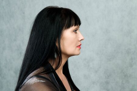 Profile of the woman of 45 years in a black dressの写真素材