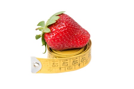 A strawberry and  measuring tape. Symbol of diet and healthy lifestyle.の写真素材