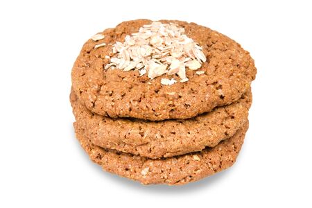 Fresh oatmeal biscuits and oat flakes on white cookiesの写真素材