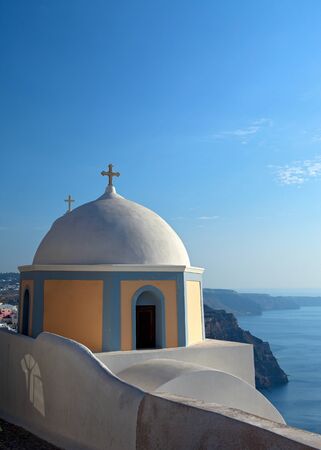 Church of the island of Santorini against the bright skyの写真素材