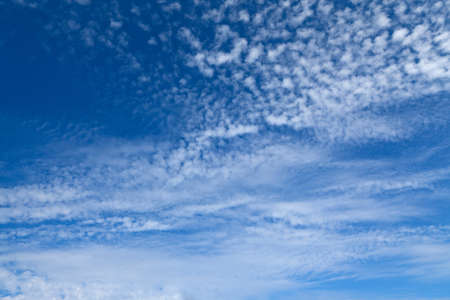 Dark blue sky and white fluffy clouds.