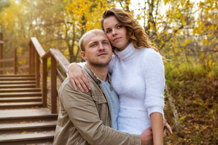 Beautiful young couple walking in autumn Parkの写真素材