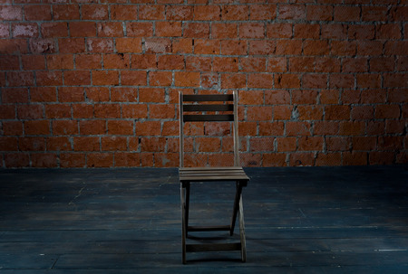 Chair in the background of the old brick wallの写真素材
