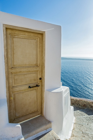 Stairs and door which go down to sea of Santorini, Greeceの写真素材