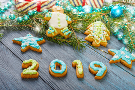 Christmas gingerbread and decorations on a blue wooden background