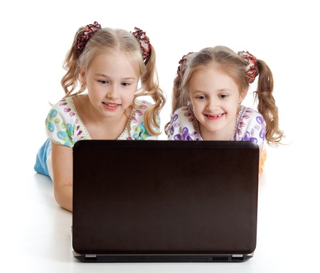 smart girlfriends smiling and looking at the laptopの写真素材