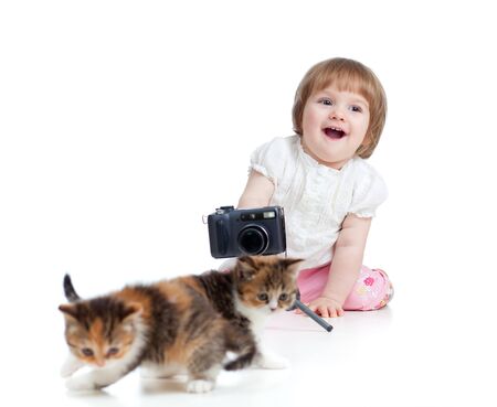 funny little girl shooting Scottish kittenの写真素材