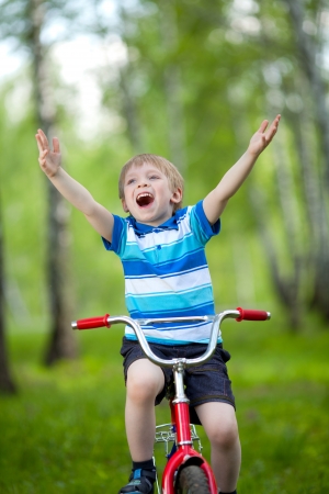Portrait of a cute child boy on bicycleの写真素材