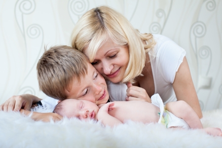 Young mother looking at her sleeping babyの写真素材