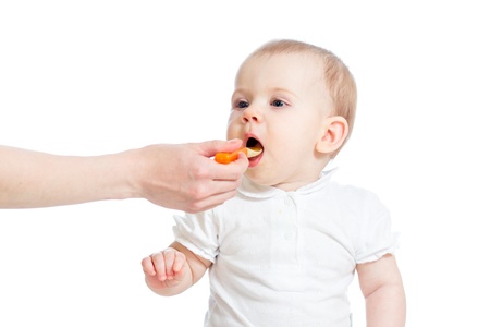Little baby feeding with a spoonの写真素材