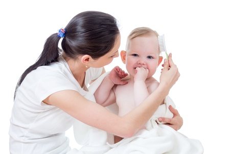 mother combing baby after bathingの写真素材