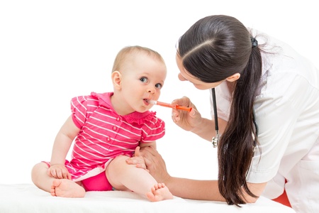 doctor giving remedy to kid girl isolated on whiteの写真素材