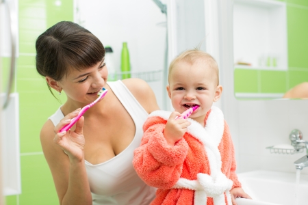 mother with baby brushing teethの写真素材