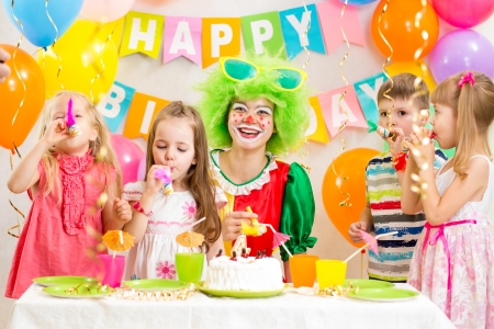 children and clown at birthday partyの写真素材