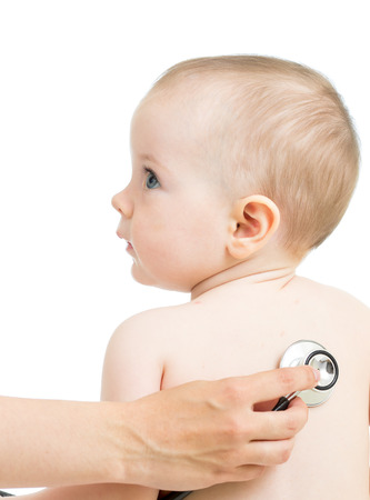 Pediatric doctor examining kid girl with stethoscope isolated on whiteの写真素材