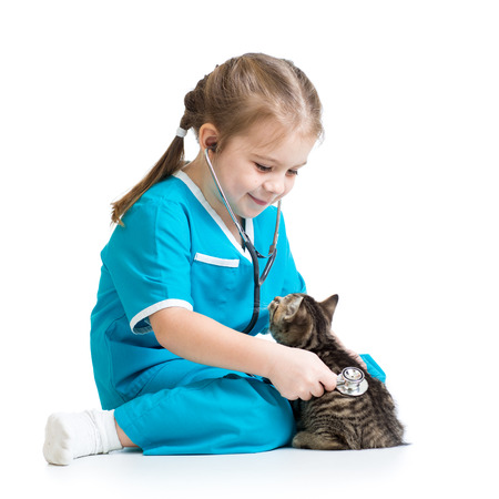 Kid girl playing doctor with kitten isolatedの写真素材