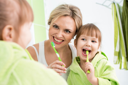 mother teaching kid teeth brushingの写真素材