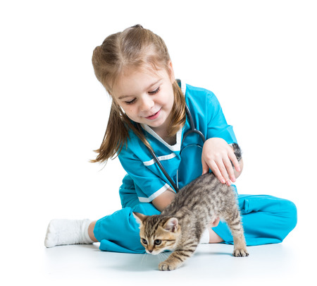 Kid girl playing doctor with cat kittenの写真素材