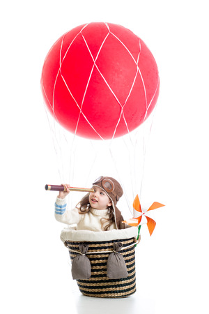 child on hot air balloon watching through spyglassの写真素材