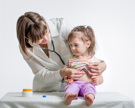 doctor examining kid girl isolated on whiteの写真素材