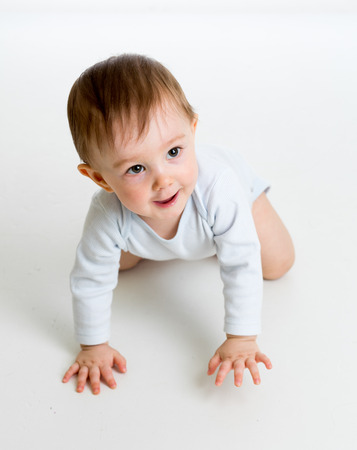 funny crawling baby boy isolated on white backgroundの写真素材