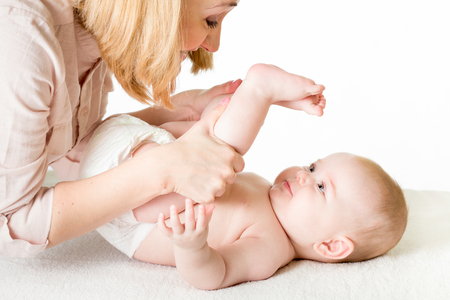 mother doing gymnastics her baby infantの写真素材