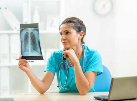 Doctor reviewing X-ray in office