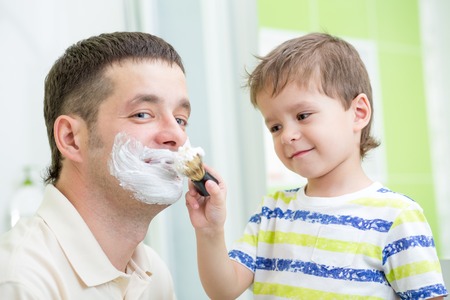 preschooler kid watching shaving of his dadの写真素材